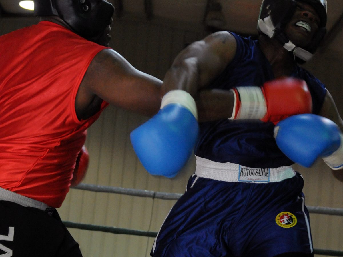 Two boxers trade punches in the ring during an amateur bout